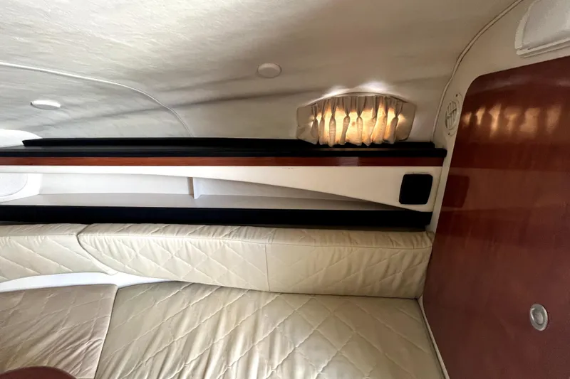 Slide: The Image of Interior of 2007 Sea Ray Sundancer 260, featuring beige upholstery and ambient lighting. - 46