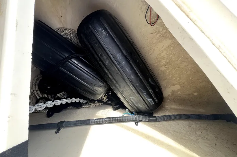 Slide: The Image of Storage compartment of 2007 Sea Ray Sundancer 260 with black fenders and ropes. - 56