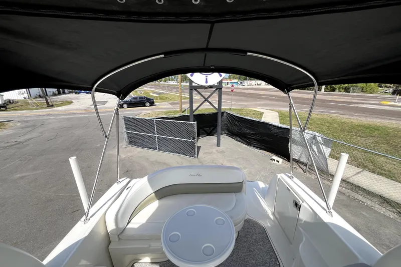 Slide: The Image of 2007 Sea Ray Sundancer 260 boat interior with seating and table under canopy. - 60