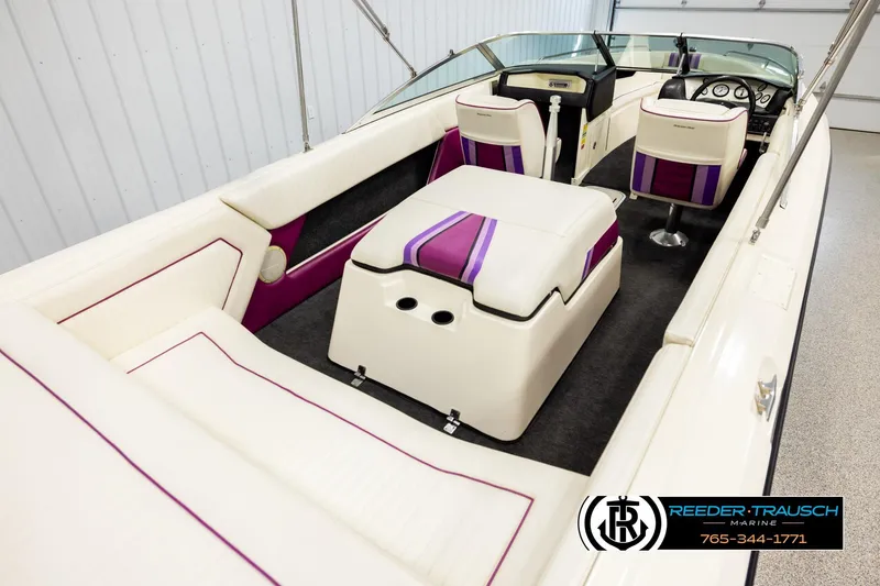 Slide: The Image of 1993 American Skier Eagle boat interior with white and purple seating, steering wheel, and dashboard. - 11