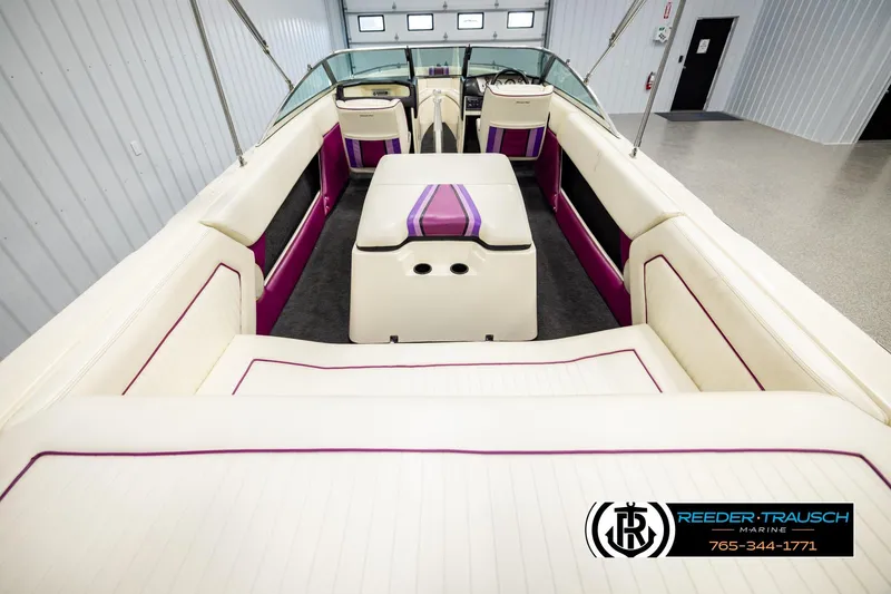 Slide: The Image of 1993 American Skier Eagle boat interior with white and purple seating, showcased indoors. - 12