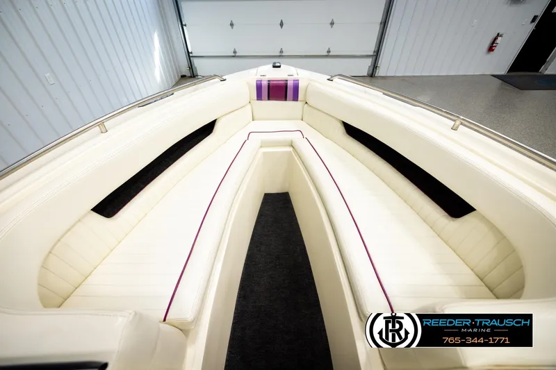 Slide: The Image of 1993 American Skier Eagle boat interior with white seating and purple accents in a garage. - 14