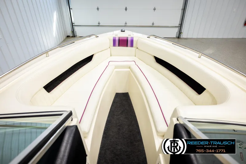 Slide: The Image of Interior of a 1993 American Skier Eagle boat with white seating and purple accents. - 18