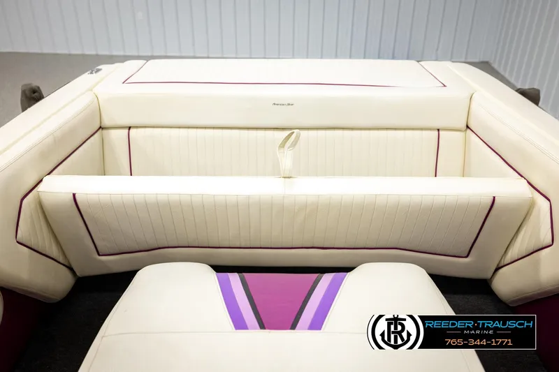 Slide: The Image of 1993 American Skier Eagle boat interior with cream upholstery and purple accents. - 21