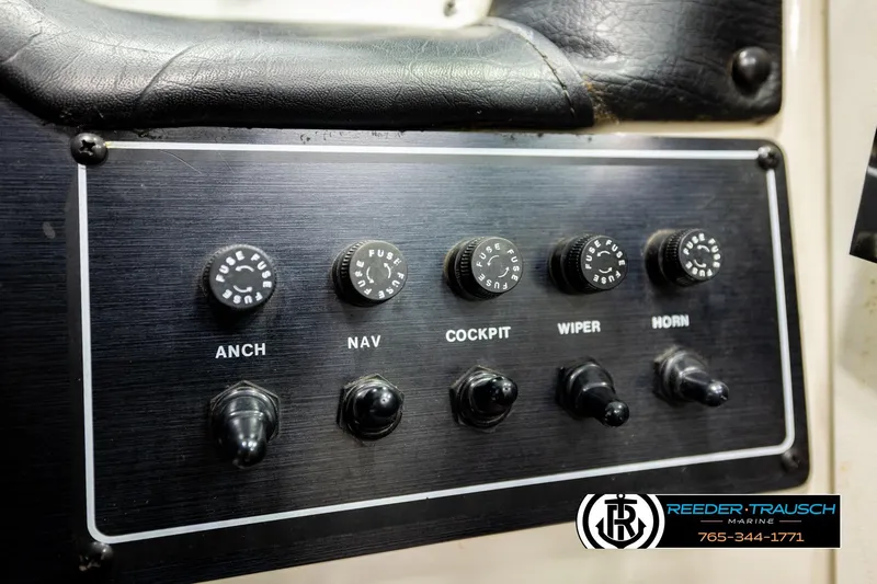 Slide: The Image of Control panel of a 1993 American Skier Eagle boat with labeled switches and fuses. - 33