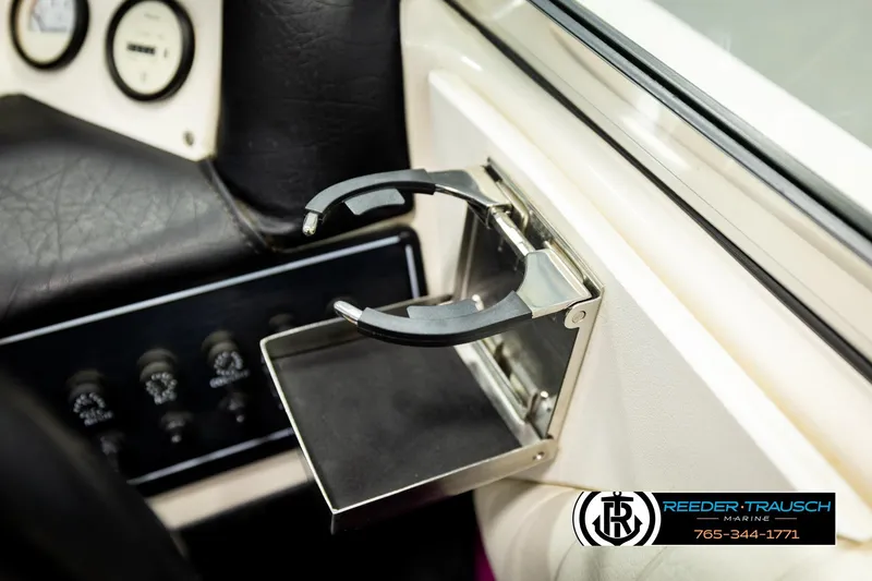 Slide: The Image of 1993 American Skier Eagle boat interior with cup holder and control panel. - 34