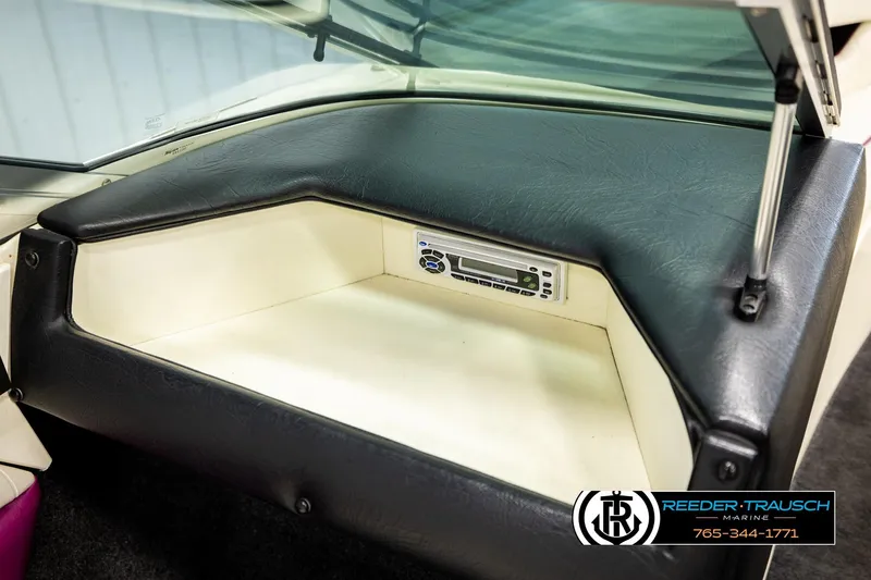 Slide: The Image of 1993 American Skier Eagle boat dashboard with storage compartment and stereo system. - 36