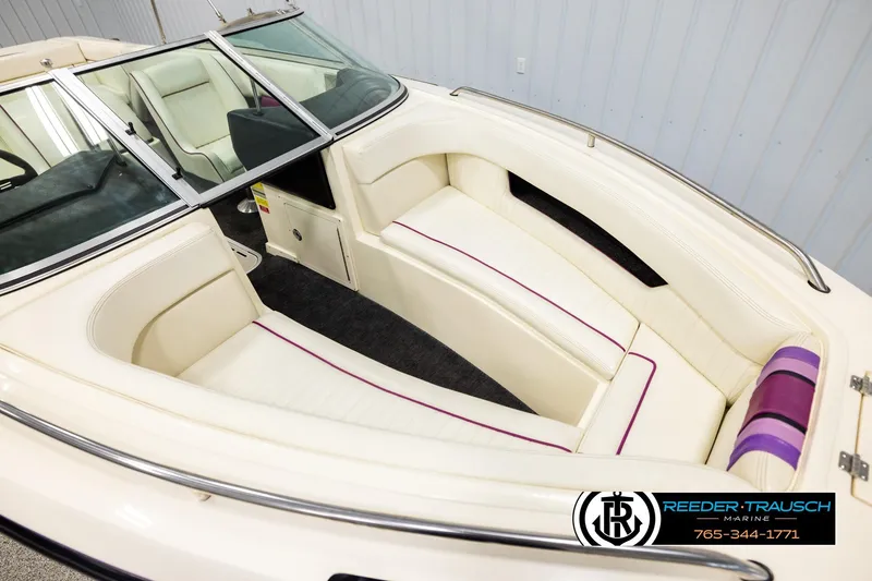 Slide: The Image of 1993 American Skier Eagle boat interior with white and purple seating, Reeder-Trausch Marine logo. - 8