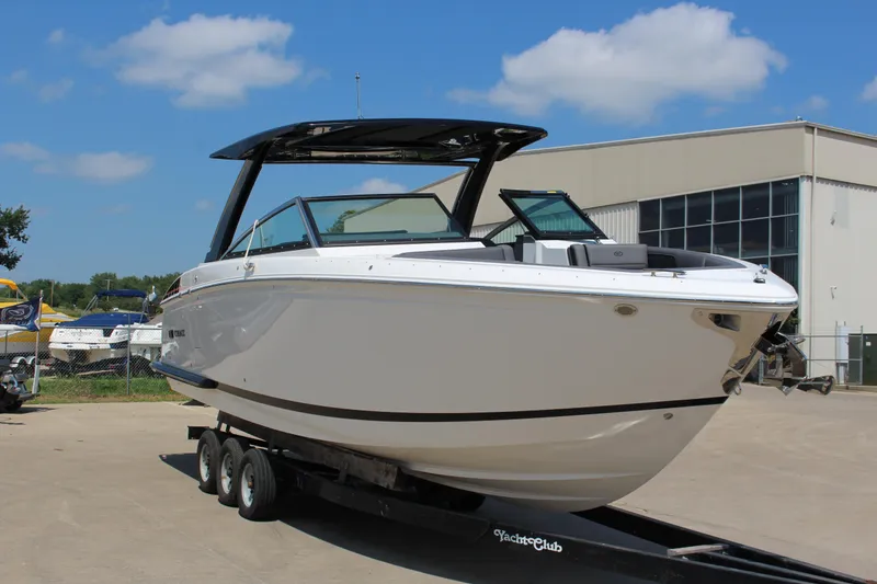 Slide: The Image of 2025 Cobalt R33 Surf boat on trailer, displayed outdoors under blue sky. - 3