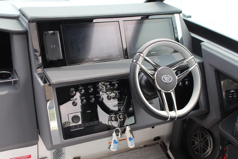 Slide: The Image of 2025 Cobalt R33 Surf boat dashboard with modern steering wheel and control panel. - 6