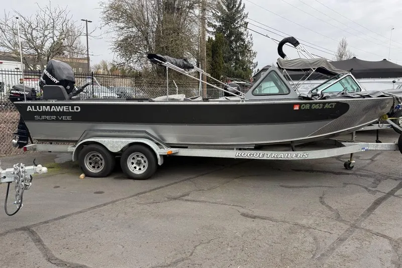 The Image of 2012 Alumaweld Super Vee Pro 23 boat on Rogue trailer, parked outdoors. - 1