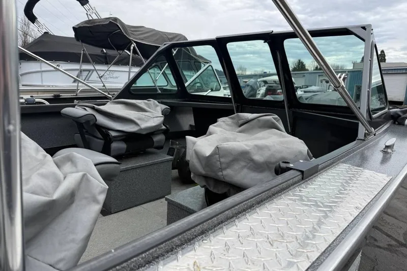 Slide: The Image of 2012 Alumaweld Super Vee Pro 23 boat interior with covered seats and windshield. - 4