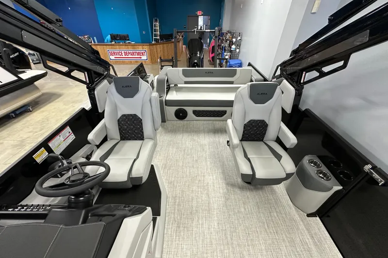 Slide: The Image of Interior of 2026 Alera M25L boat with modern seating and steering wheel. - 10