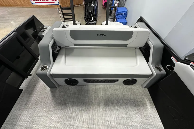 Slide: The Image of 2026 Alera M25L boat interior with gray seating and cup holders. - 11