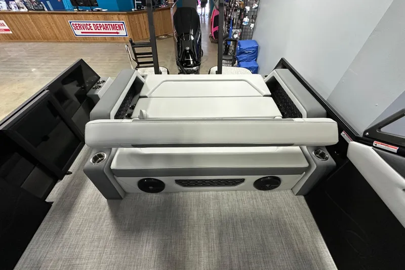 Slide: The Image of 2026 Alera M25L boat interior with gray seating and cup holders. - 12