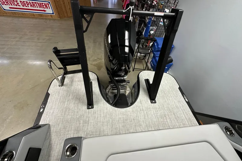 Slide: The Image of 2026 Alera M25L boat with motor and ladder, displayed indoors near service department. - 15