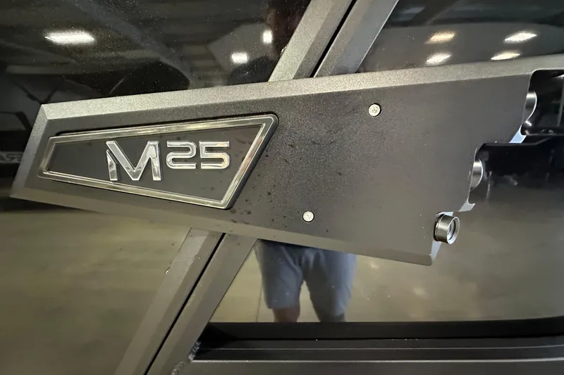 Slide: The Image of Close-up of 2026 Alera M25L emblem on a sleek, metallic surface. - 3