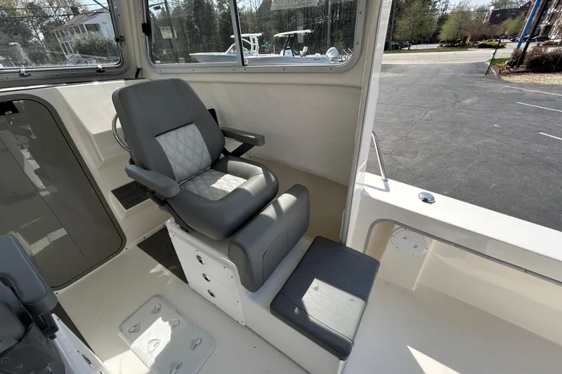Slide: The Image of 2026 May-Craft 245 Pilot House interior with comfortable seating and modern design. - 15