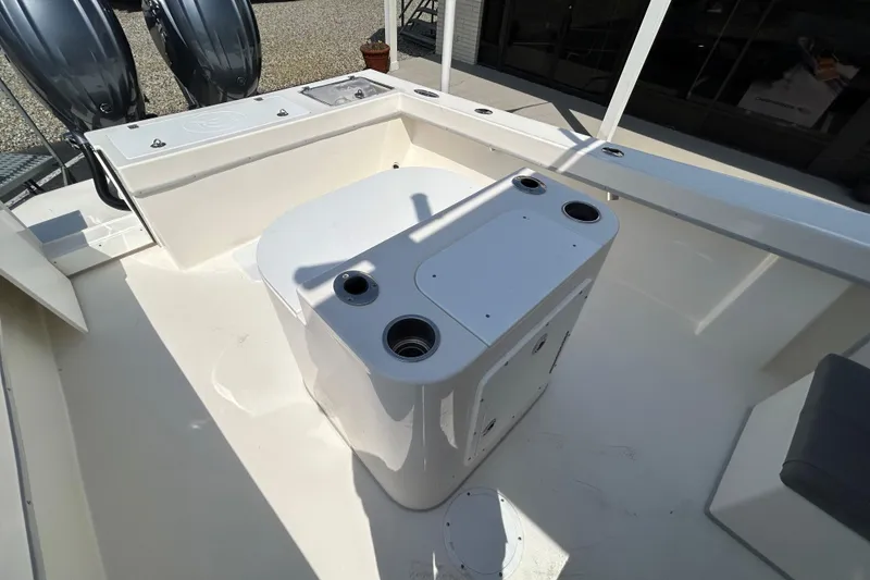 Slide: The Image of 2026 May-Craft 245 Pilot House boat deck with dual engines and storage compartments. - 16