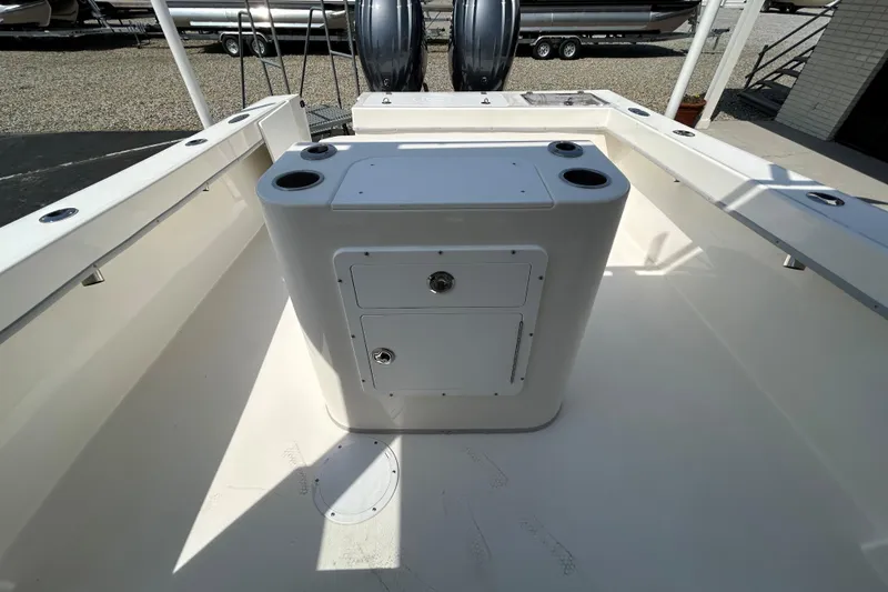 Slide: The Image of 2026 May-Craft 245 Pilot House boat interior with storage and cup holders. - 17