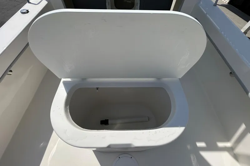 Slide: The Image of Open storage compartment on 2026 May-Craft 245 Pilot House boat deck. - 19