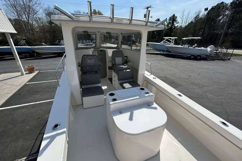 Slide: The Image of 2026 May-Craft 245 Pilot House boat interior with seating and helm station. - 22