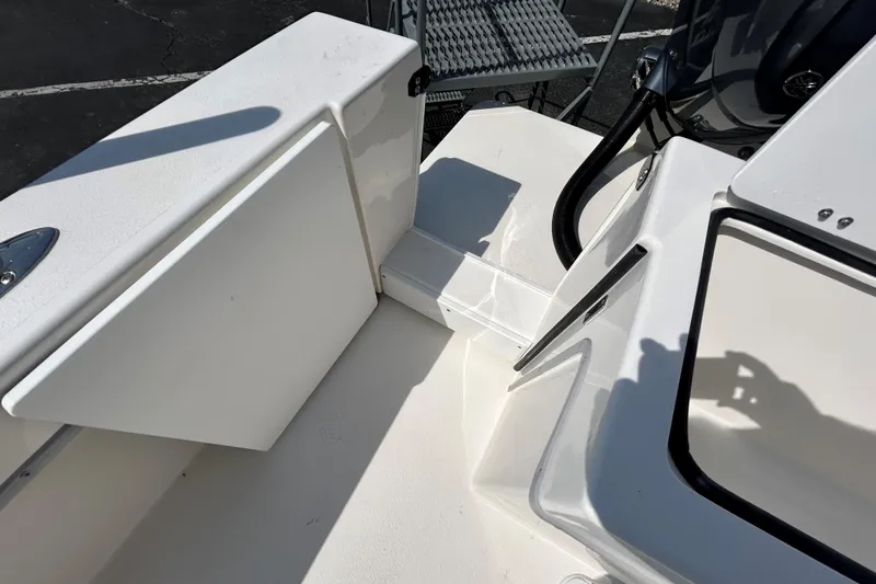 Slide: The Image of 2026 May-Craft 245 Pilot House boat deck with storage compartments. - 23