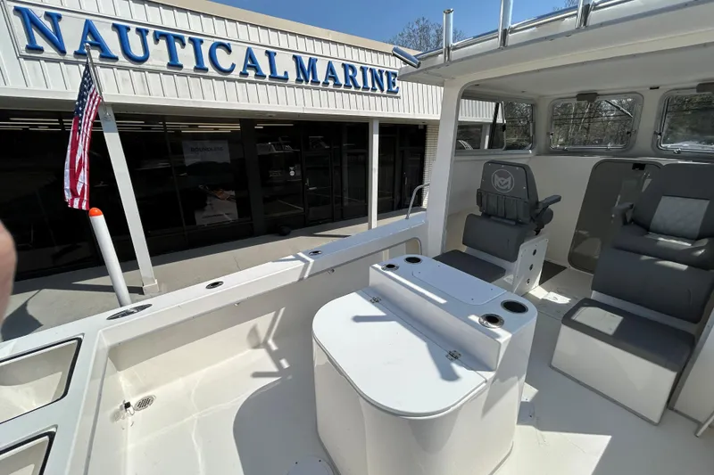 Slide: The Image of 2026 May-Craft 245 Pilot House boat interior at Nautical Marine dealership. - 24