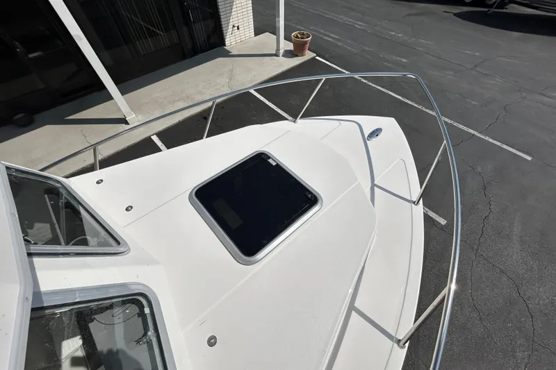 Slide: The Image of 2026 May-Craft 245 Pilot House boat deck with railing and hatch. - 25