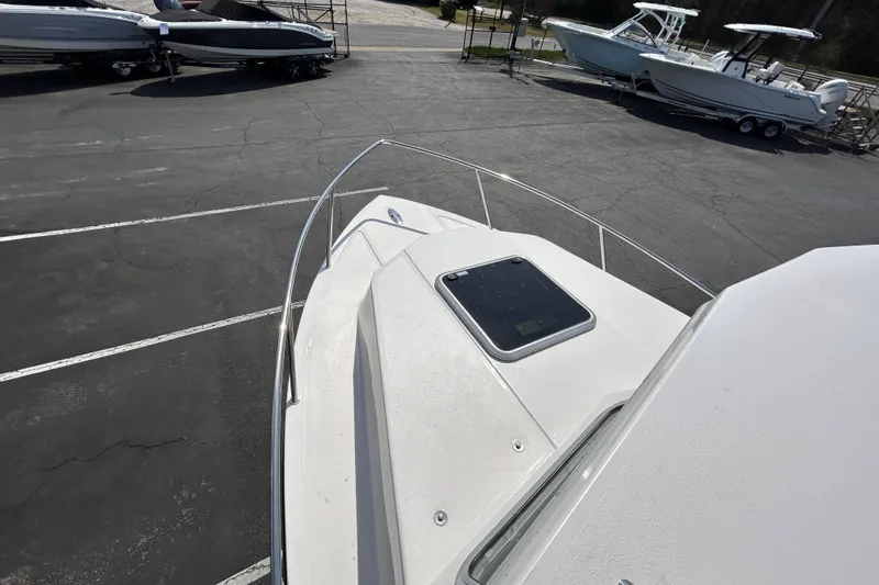 Slide: The Image of 2026 May-Craft 245 Pilot House boat on display in a parking lot. - 27