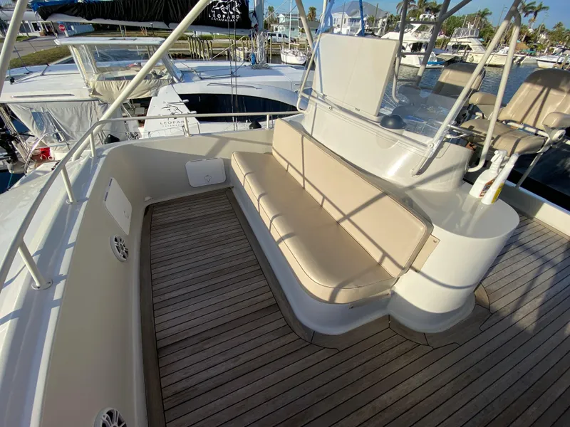 Slide: The Image of Mares 58 Power Cat 1995 boat deck with cushioned seating and wooden flooring. - 16