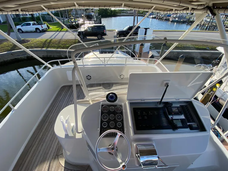Slide: The Image of 1995 Mares 58 Power Cat helm with steering wheel, gauges, and waterfront view. - 17