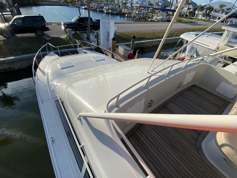 Slide: The Image of 1995 Mares 58 Power Cat docked, showcasing spacious deck and sleek design. - 18