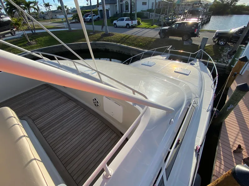 Slide: The Image of 1995 Mares 58 Power Cat docked, showcasing sleek design and spacious deck. - 19