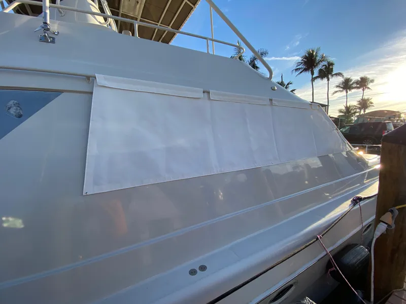 Slide: The Image of 1995 Mares 58 Power Cat yacht with sunshade, docked under clear blue sky. - 25