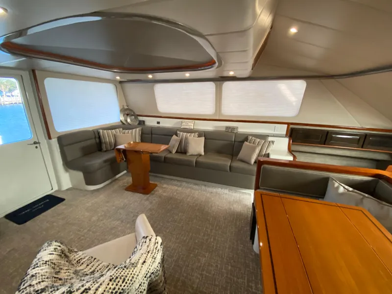 Slide: The Image of Spacious interior of 1995 Mares 58 Power Cat with modern seating and wooden accents. - 33