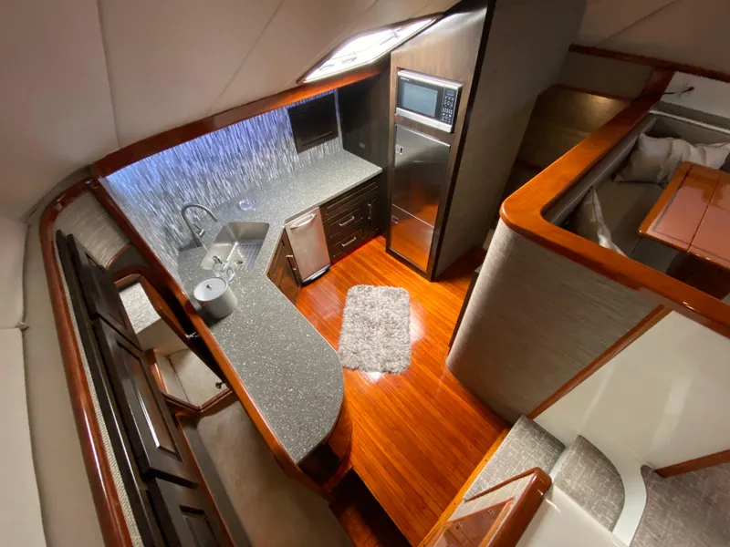 Slide: The Image of Luxurious interior of 1995 Mares 58 Power Cat with modern kitchen and wood flooring. - 35