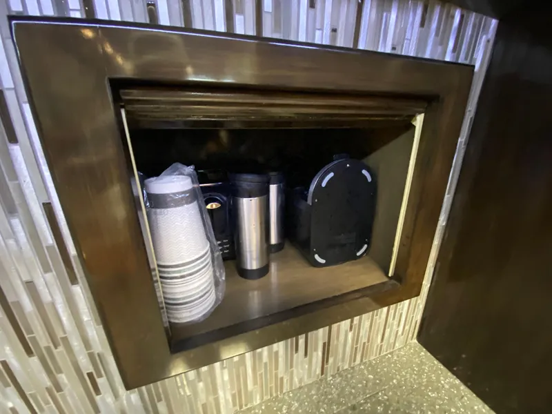 Slide: The Image of Storage compartment with cups and thermoses on a Mares 58 Power Cat, 1995 model. - 38