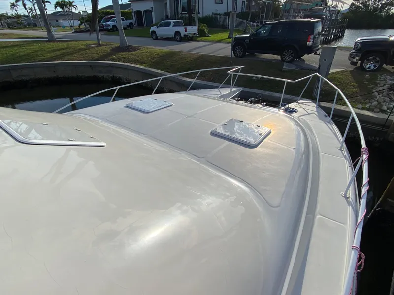 Slide: The Image of 1995 Mares 58 Power Cat boat docked, showing deck and railing. - 4