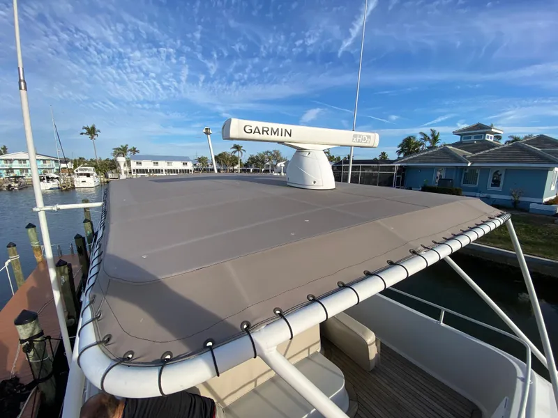 Slide: The Image of 1995 Mares 58 Power Cat with Garmin radar, docked near waterfront homes. - 8