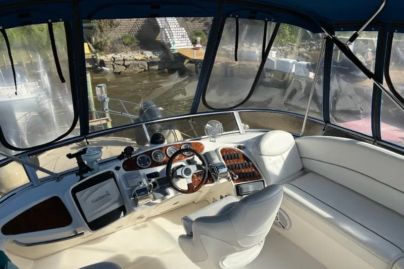 Slide: The Image of Interior view of 2004 Meridian 459 Motoryacht helm with steering wheel and navigation equipment. - 12