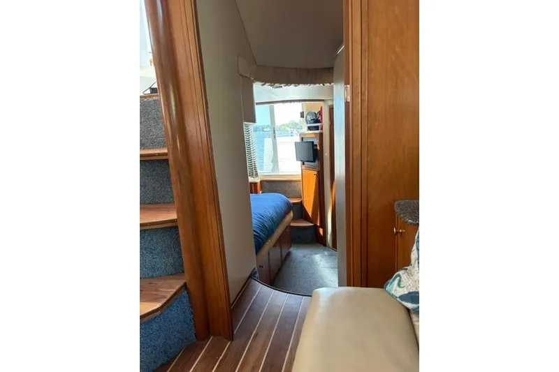 Slide: The Image of Interior view of 2004 Meridian 459 Motoryacht cabin with wooden finishes and cozy bed. - 15