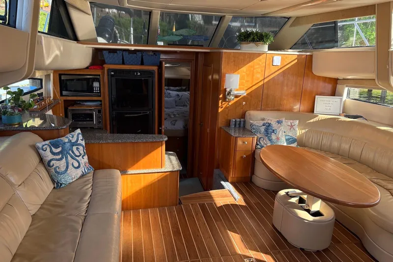 Slide: The Image of Luxurious 2004 Meridian 459 Motoryacht interior with elegant wood finishes and plush seating. - 16
