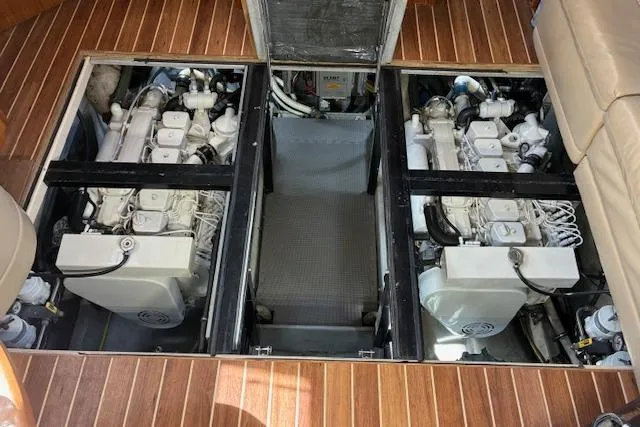 Slide: The Image of Engine room of 2004 Meridian 459 Motoryacht with twin engines on wooden flooring. - 24