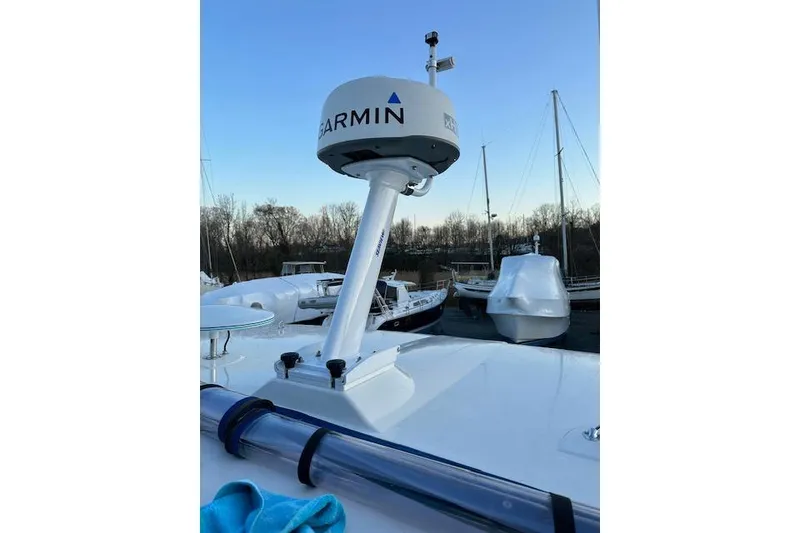 Slide: The Image of 2004 Meridian 459 Motoryacht with Garmin radar, docked with other boats in the background. - 25
