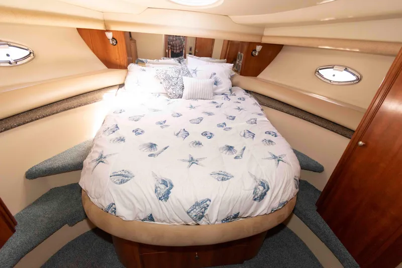 Slide: The Image of Luxurious bedroom interior of 2004 Meridian 459 Motoryacht with nautical-themed bedding. - 26