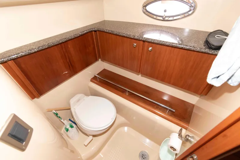 Slide: The Image of Bathroom interior of 2004 Meridian 459 Motoryacht with wooden cabinets and porthole window. - 27