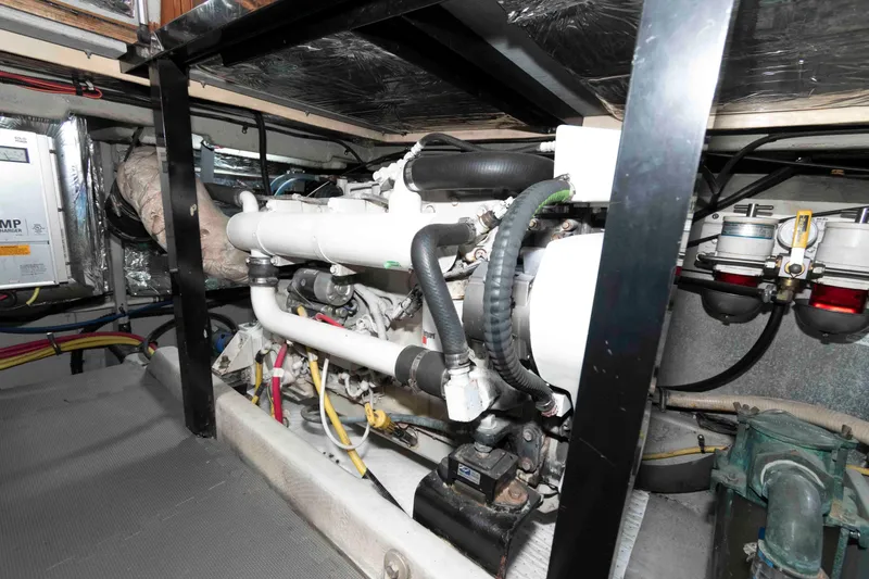Slide: The Image of Engine room of a 2004 Meridian 459 Motoryacht, showcasing mechanical components and piping. - 31