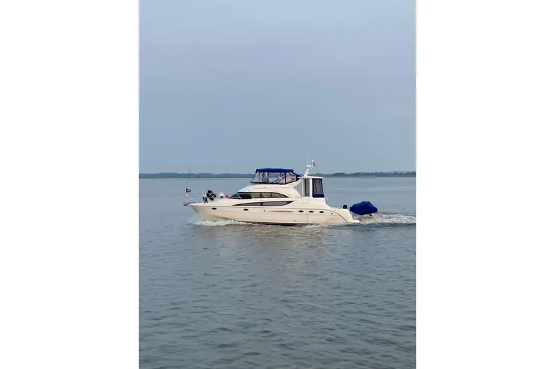 Slide: The Image of 2004 Meridian 459 Motoryacht cruising on calm waters under a clear sky. - 4