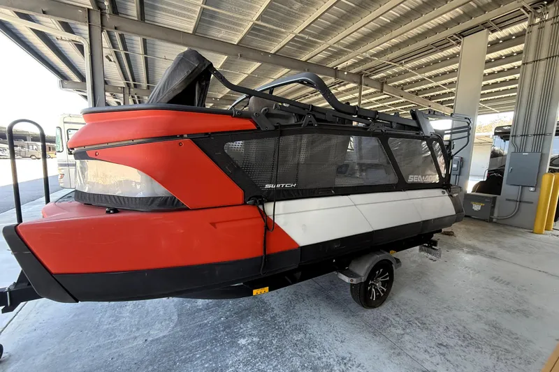 Slide: The Image of 2022 Sea-Doo Switch Cruise 18 under a metal canopy, showcasing its sleek design. - 0